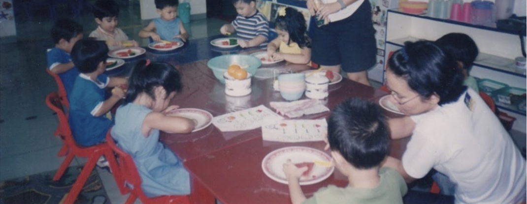School archive: children sharing a meal around a classroom table